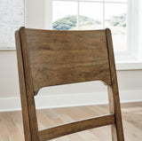 Rear angled view showcasing Cabalynn dining chair wooden frame and fabric upholstery