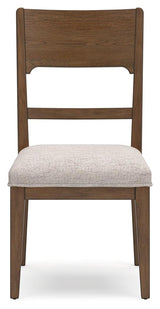 Dining room setup featuring Cabalynn oatmeal light brown dining chairs