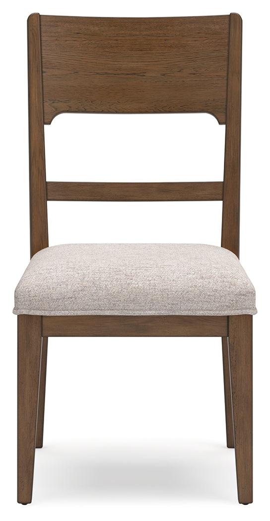 Dining room setup featuring Cabalynn oatmeal light brown dining chairs