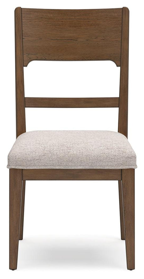 Dining room setup featuring Cabalynn oatmeal light brown dining chairs