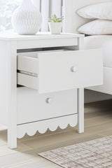 Close-up detail of scalloped edge on nightstand corner