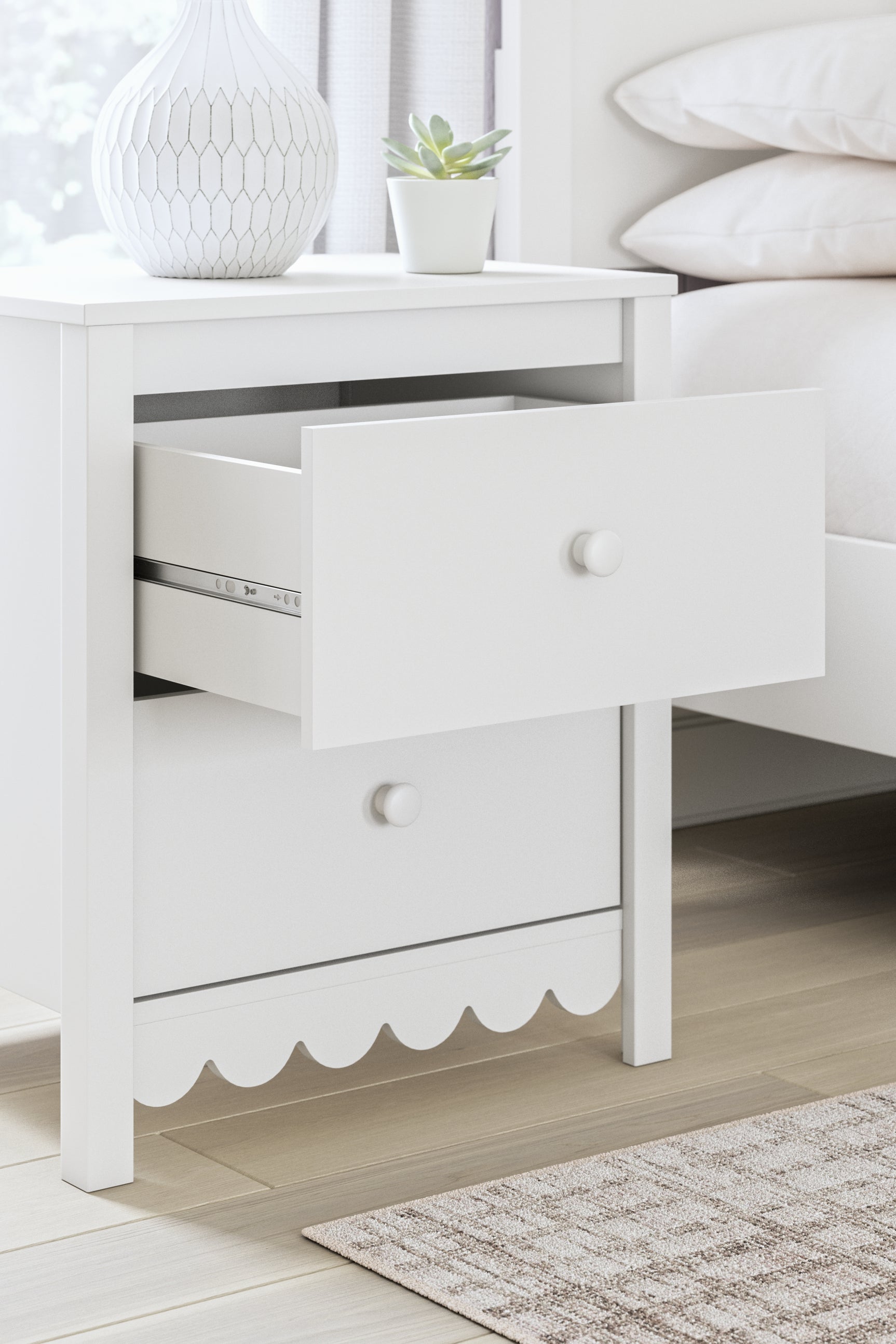 Close-up detail of scalloped edge on nightstand corner
