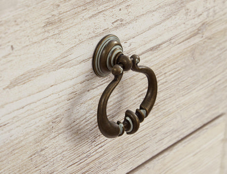 Close-up of antiqued brass-tone ring pull hardware