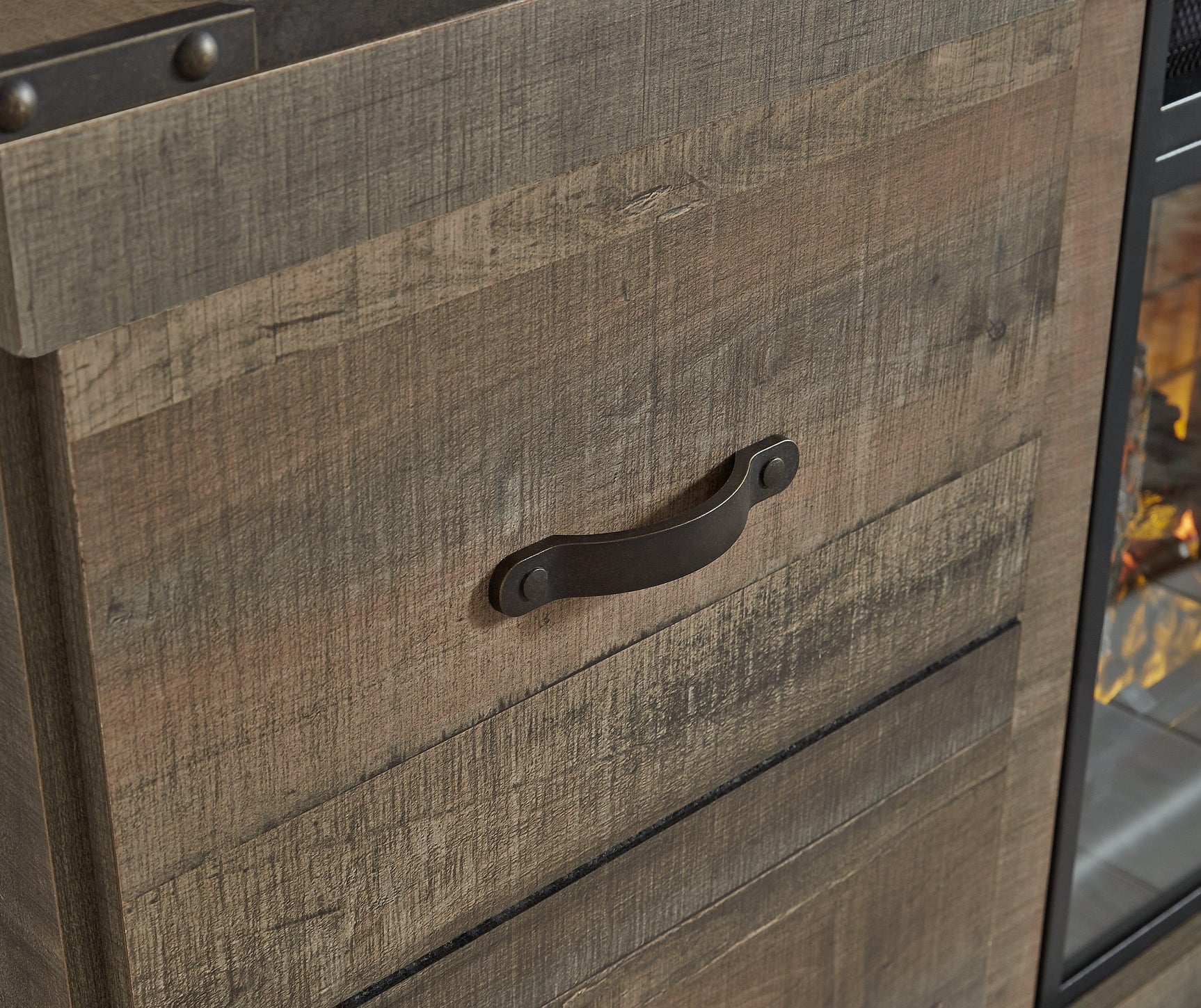 Detail of dark bronze-tone hardware on cabinet door