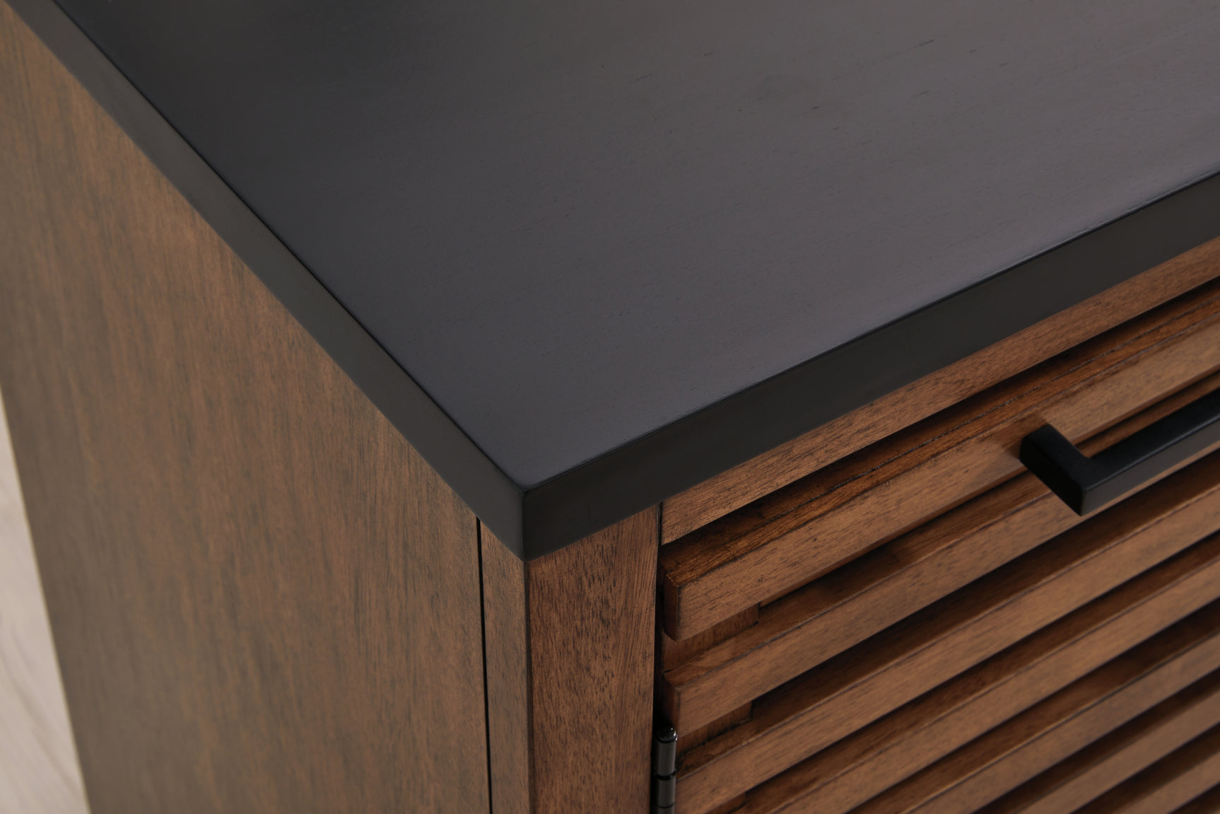 Close-up of warm brown and matte black finish on Kallari credenza