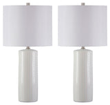 Pair of Steuben white ceramic table lamps on side table