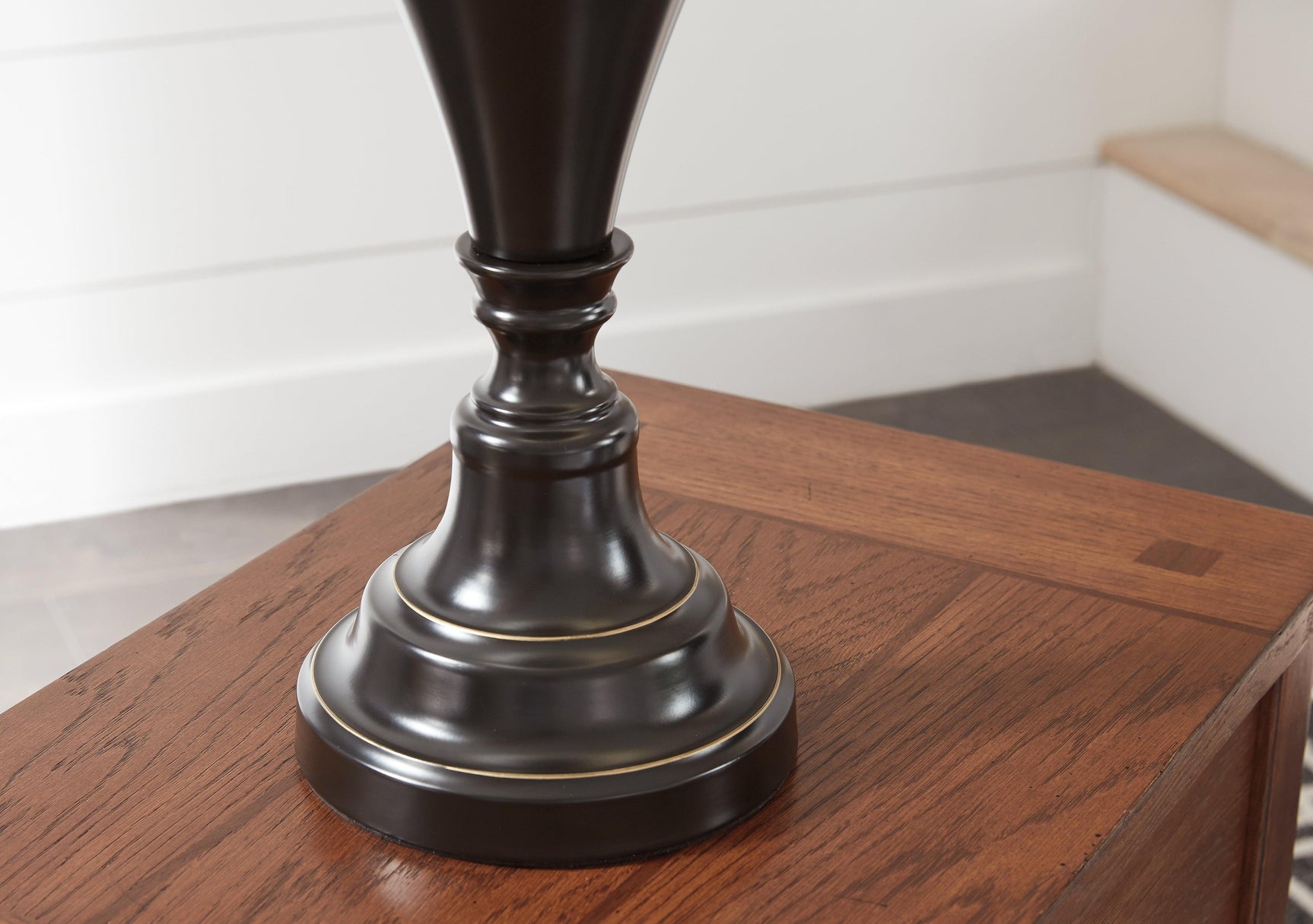 Detail of turned pedestal base on Darlita bronze finish table lamp