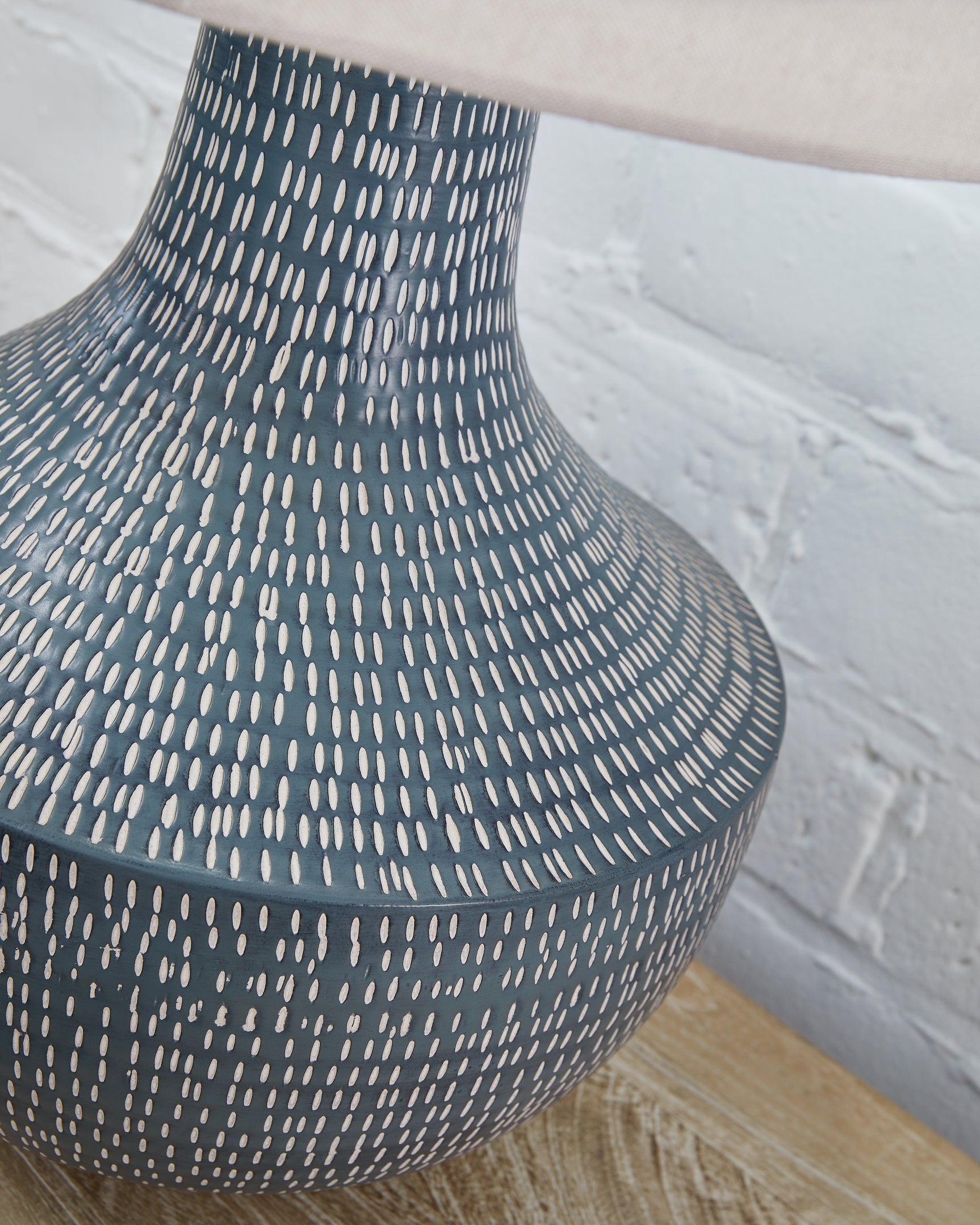 Detail of hammered metal texture on lamp base