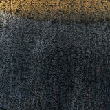 Detail of Adara table lamp's blue and gold finish on metal base