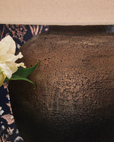 Close-up detail of textured metallic brown and black lamp base