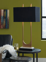 Close-up of Malana table lamp's brass finish and black fabric shade