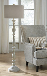 Bernadate floor lamp illuminated in a living room setting