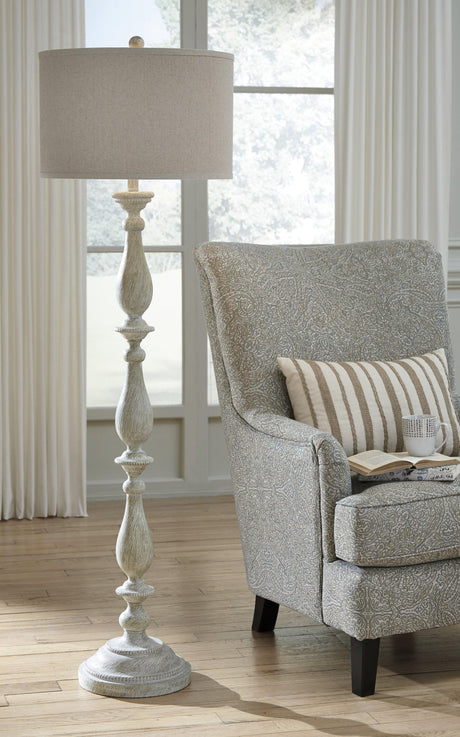 Bernadate floor lamp illuminated in a living room setting