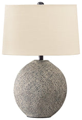 Harif Beige Table Lamp lit on bedside table