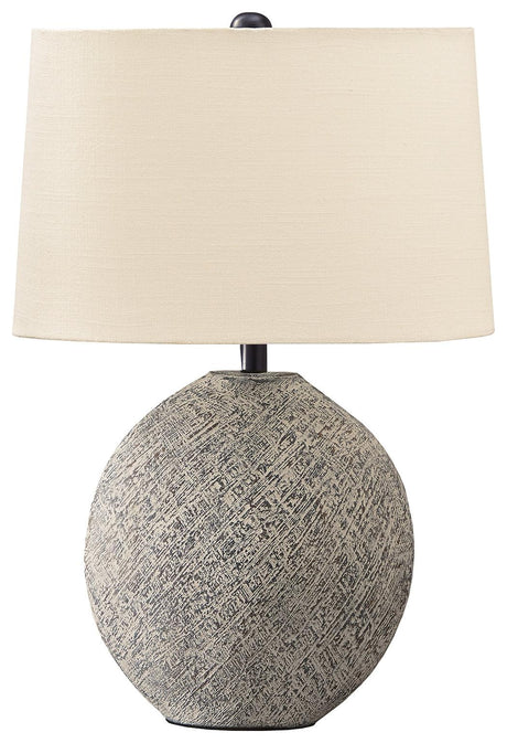 Harif Beige Table Lamp lit on bedside table