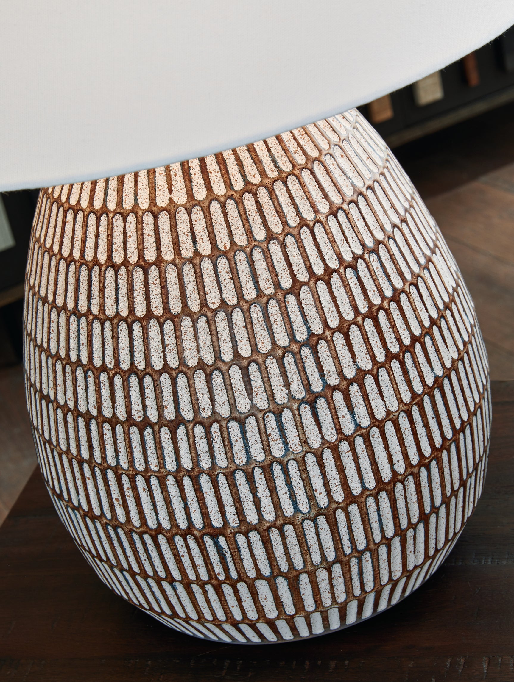 Detail of metal base with distressed beige and white finish