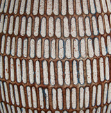 Finish detail of beige and white distressed metal base