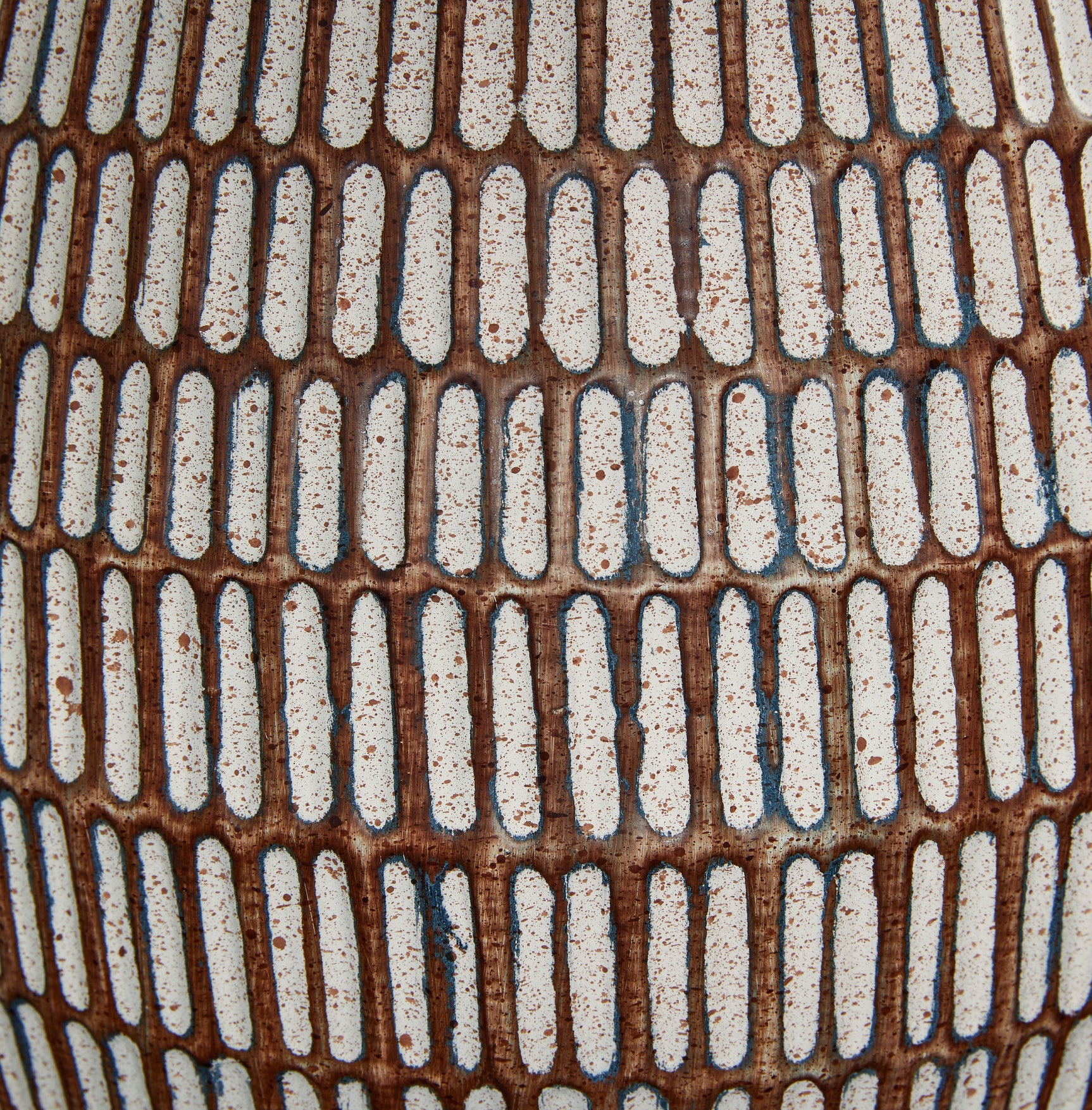 Finish detail of beige and white distressed metal base