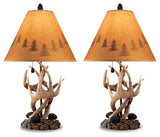Close-up of Derek Brown lamp base with antler and pinecone detail