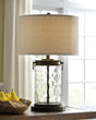 Tailynn table lamp with clear wave glass and bronze finish, angled side view