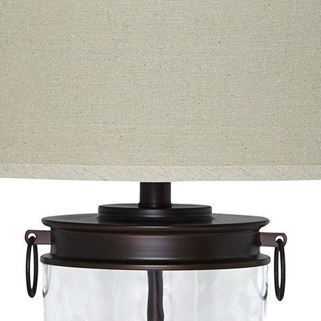 Close-up of Tailynn table lamp bronze finish and clear glass base
