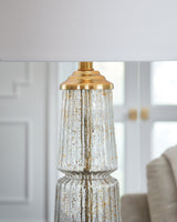Close-up of clear fluted glass with gold flecks on lamp base