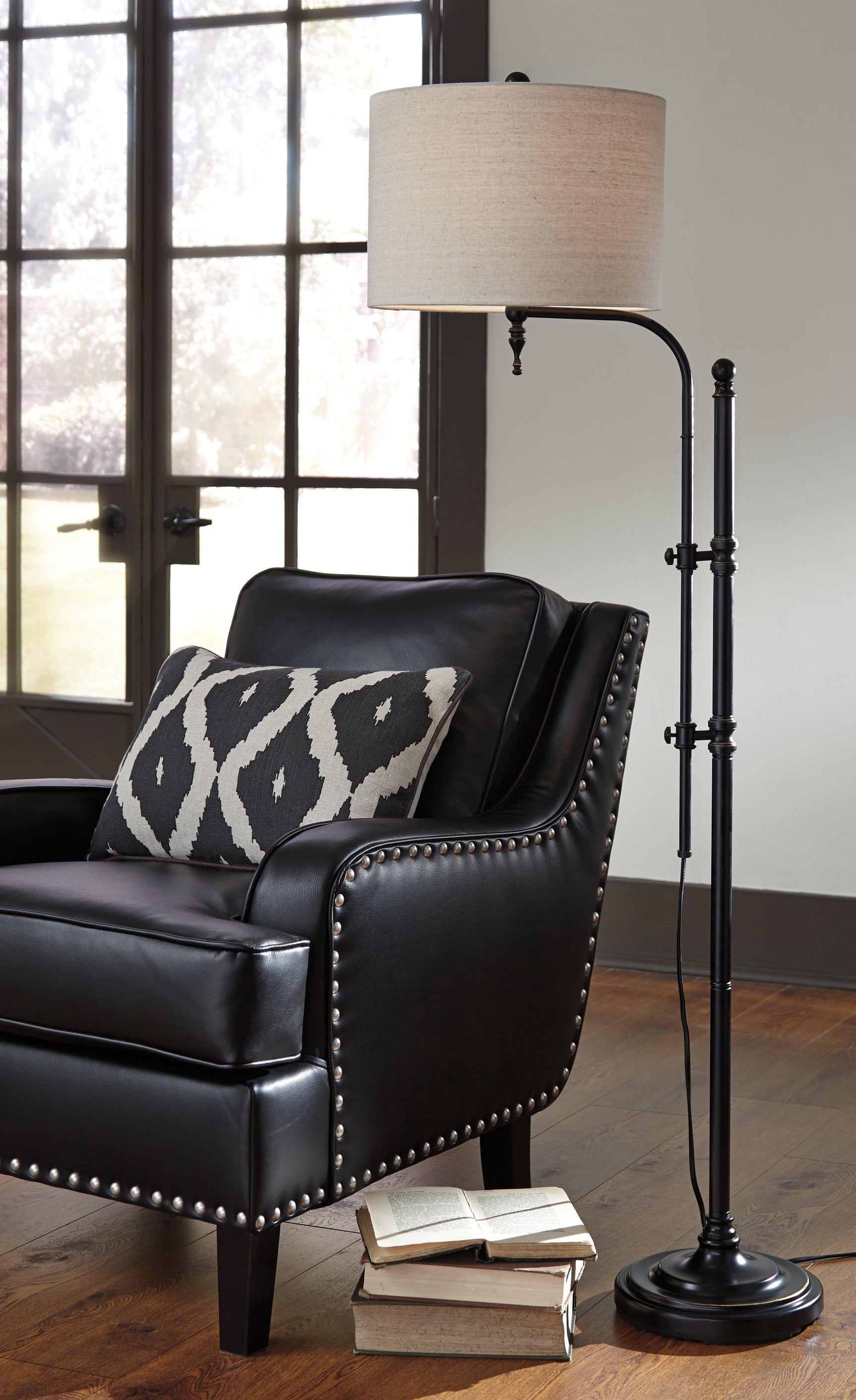 Close-up of white fabric drum shade and black metal base