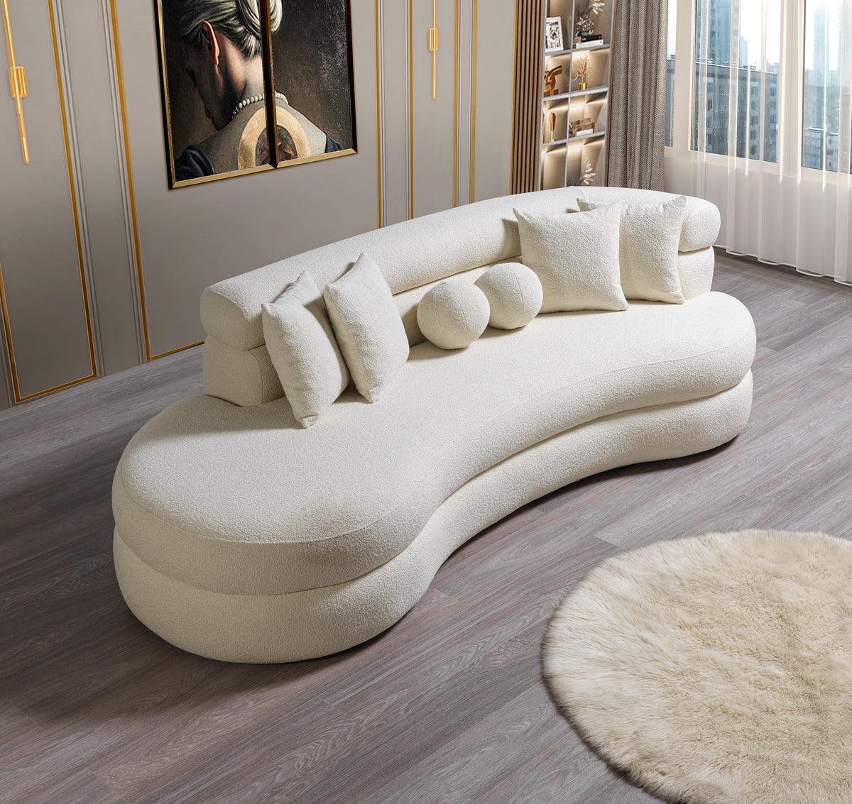 Side perspective of ivory boucle chaise lounge