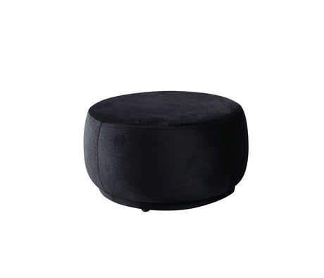 Ava Black Velvet Round Ottoman angled side view showing velvet upholstery