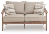 Front-on view of loveseat with cushions and pillows
