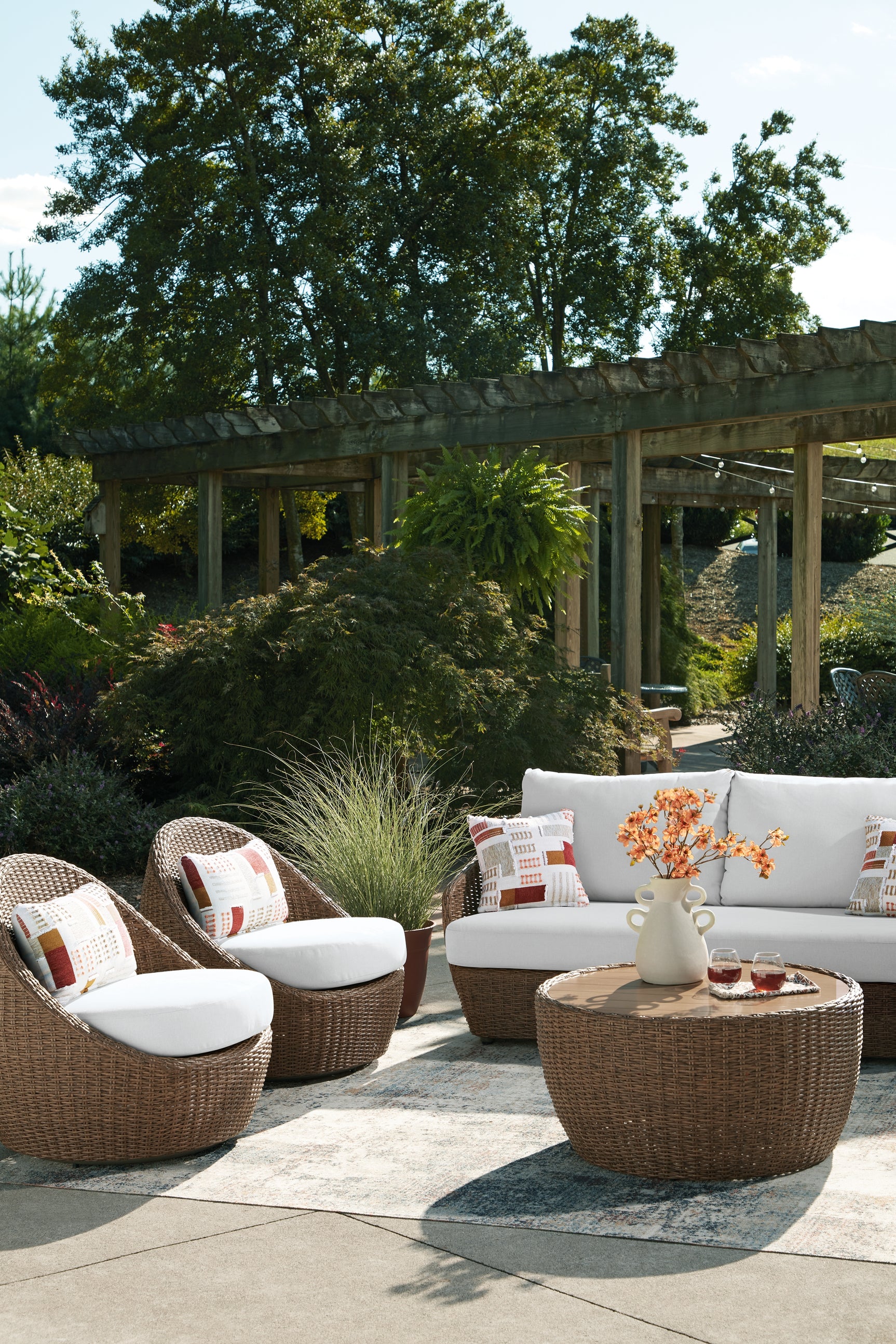 Double beige outdoor sofa set with loveseat, lounge chairs, and coffee table