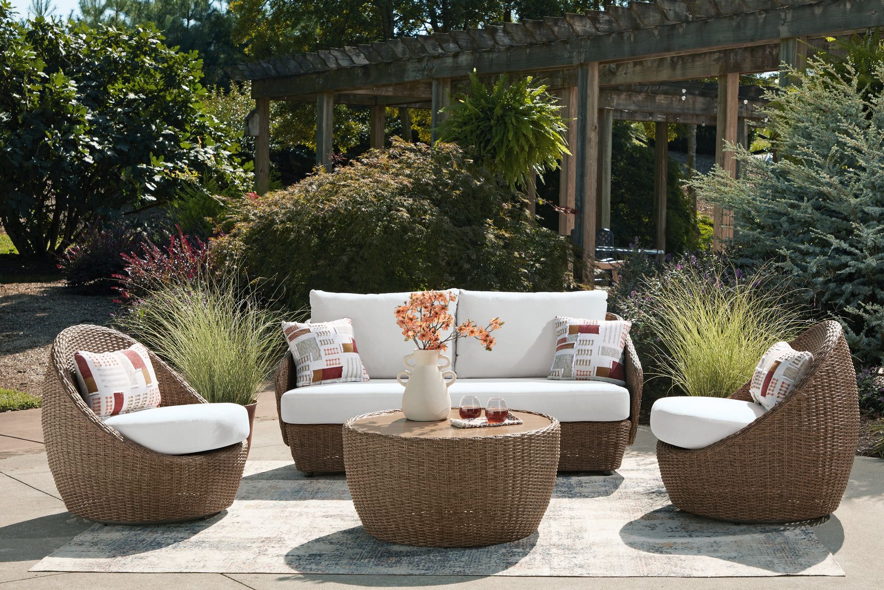 Outdoor coffee table paired with beige resin wicker seating