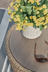 Detailed view of handwoven beige resin wicker and frame