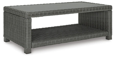 Angled view of loveseat and coffee table set on patio