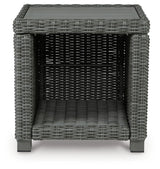 End table side angle showcasing frame and wicker