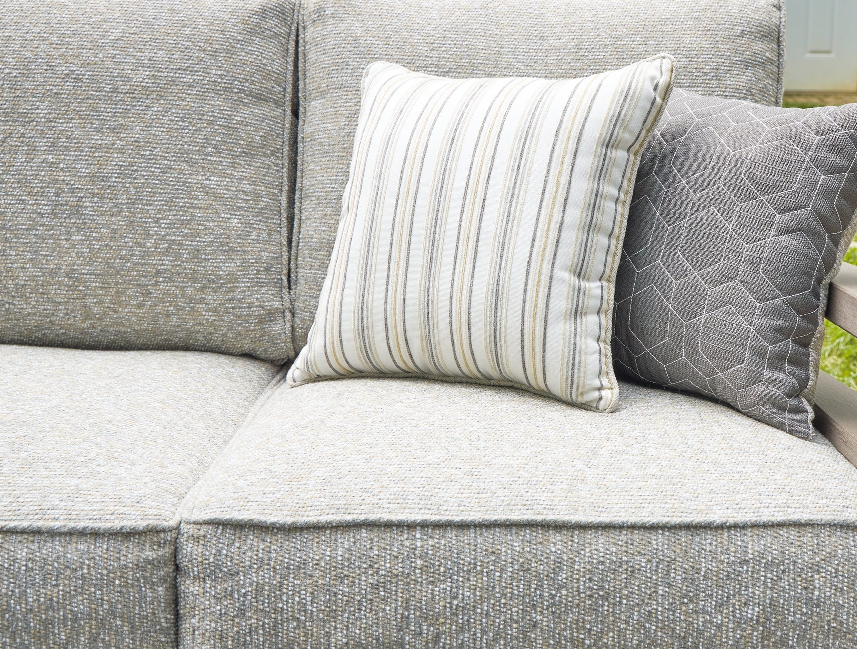 Close-up of four throw pillows on Hillside Barn outdoor sofa