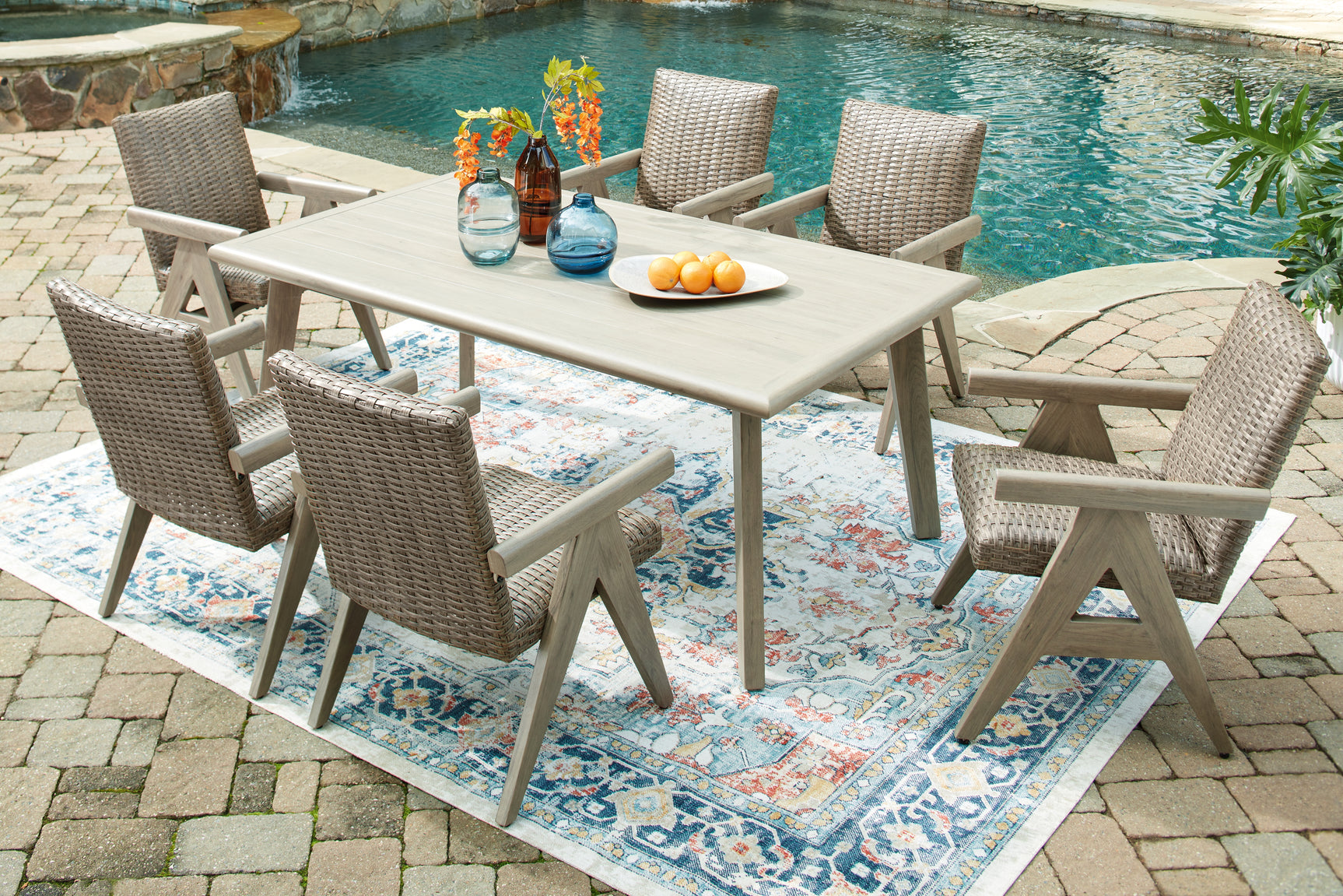 Outdoor dining table detail showing wood-look top