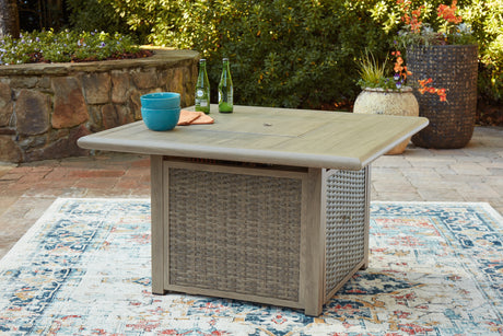 Outdoor fire pit table and chair set on patio