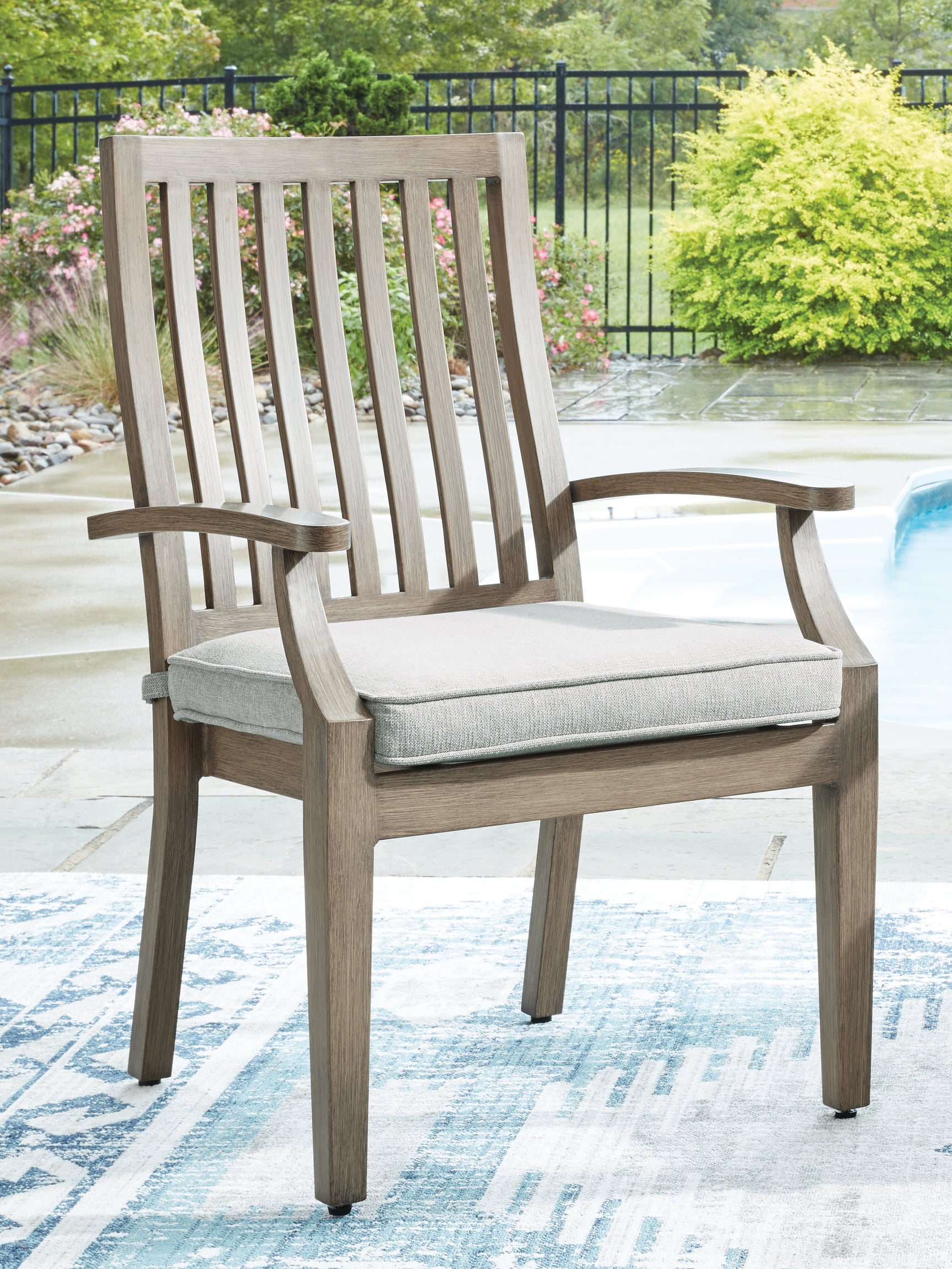 Rainier Ranch outdoor dining table and four beige cushioned chairs