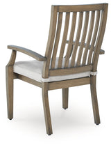 Rainier Ranch outdoor dining table and four beige cushioned chairs