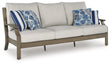 Rainier Ranch outdoor sofa with brown and beige cushions, angled view