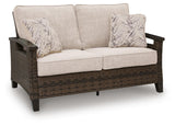Close-up of Monterey Point loveseat seat cushions and throw pillows