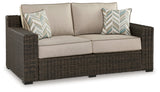 Coastline Bay Outdoor Loveseat head-on view showing cushions and wicker detail