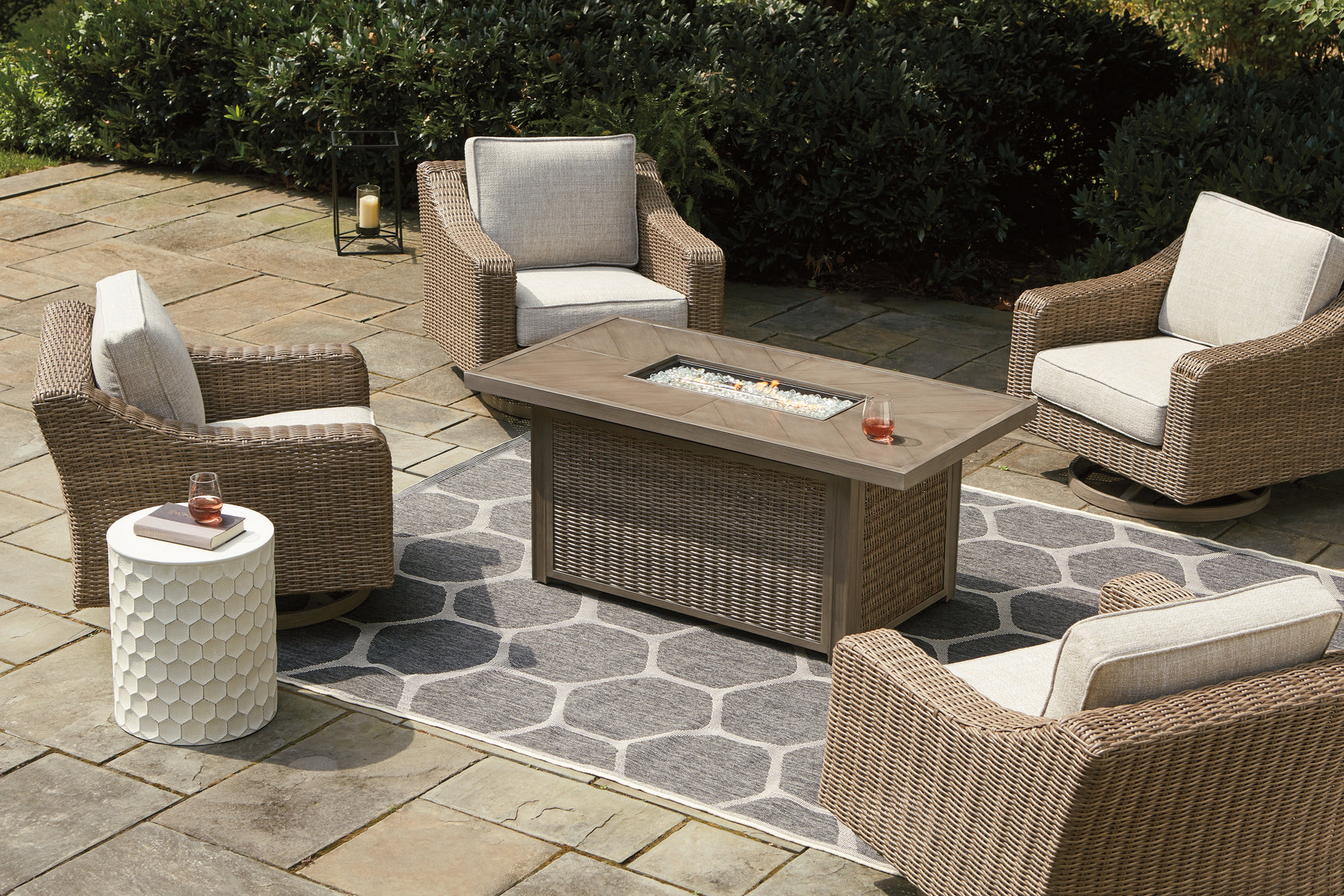 Fire pit table lit with stainless steel burner