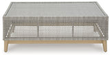Side view of Seton Creek Gray Outdoor Coffee Table showing wood-look painted legs