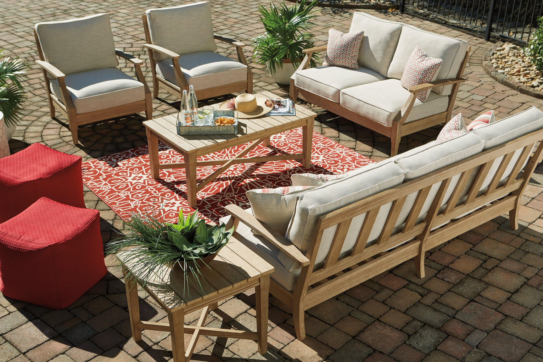 Clare View Beige Sofa styled with neutral pillows outdoors
