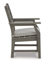 Outdoor chairs arranged around table on patio