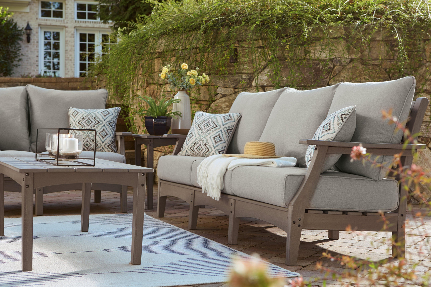 Visola Gray Outdoor Sofa with cushions lifestyle setting horizontal