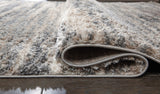 Rolled section of Gizela Ivory Beige Gray striped rug