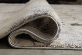 Wyscott multi-color 7'10" x 10'3" rug rolled showing side edge